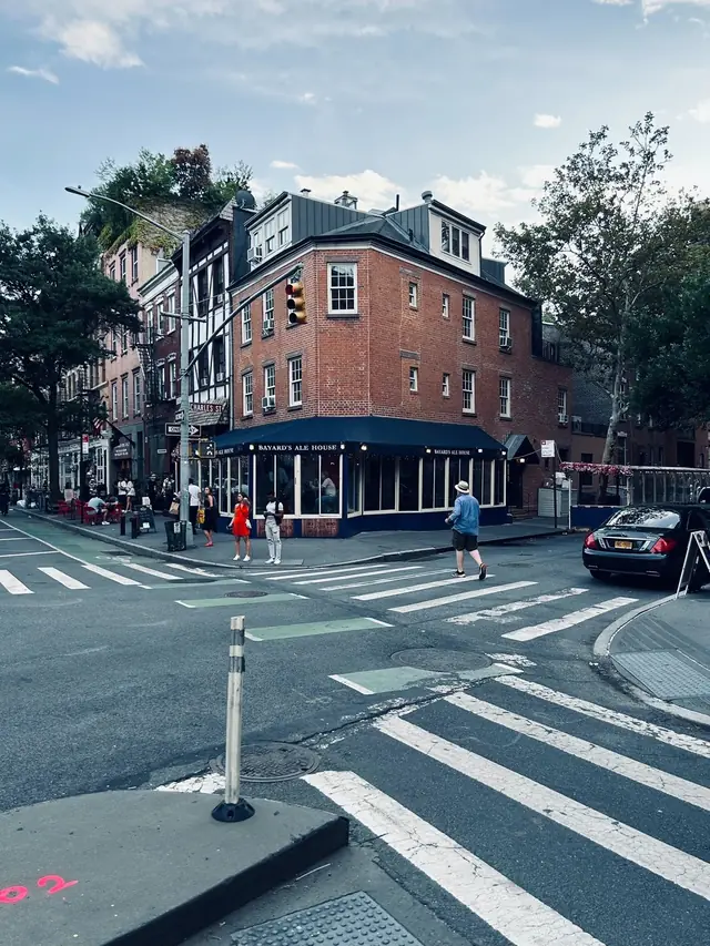 A brick corner building above a New York crosswalk